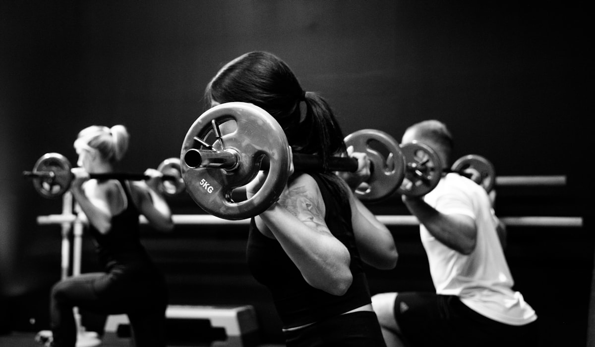 Professional strength training coach demonstrating proper form